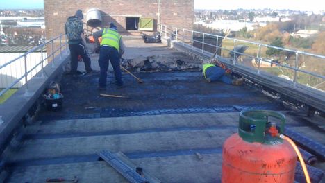 Roofers installing a flat roof